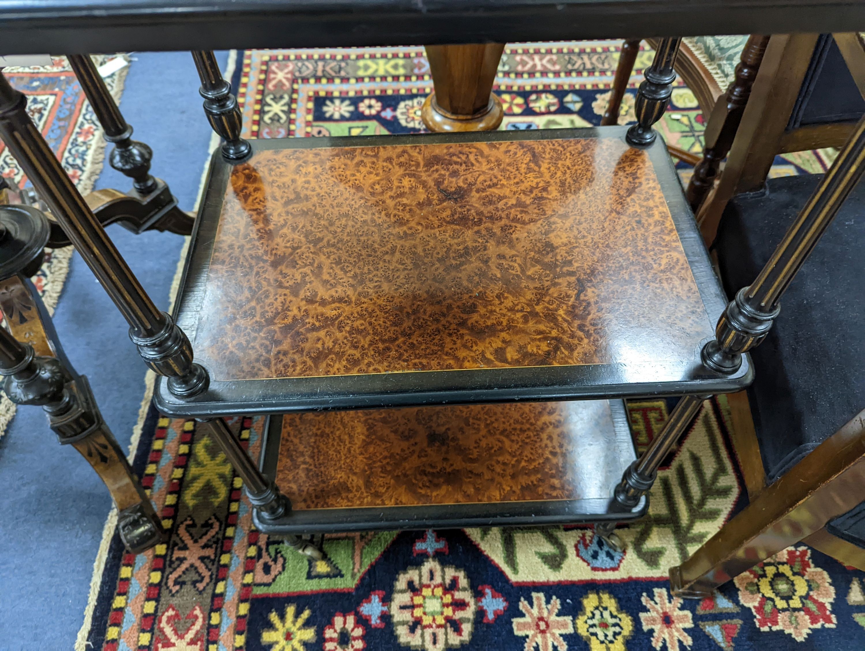 A late Victorian part ebonised Amboyna three tier whatnot with brass galleried top, width 49cm, depth 33cm, height 83cm